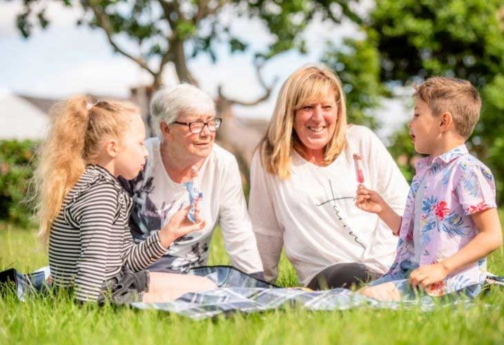 Two foster carers Debbie and Dot with foster children eating ice cream