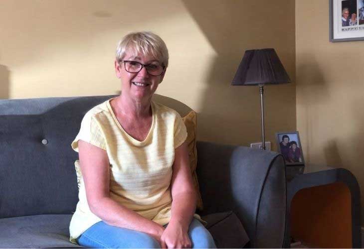 Foster carer, Jacquie sitting on sofa