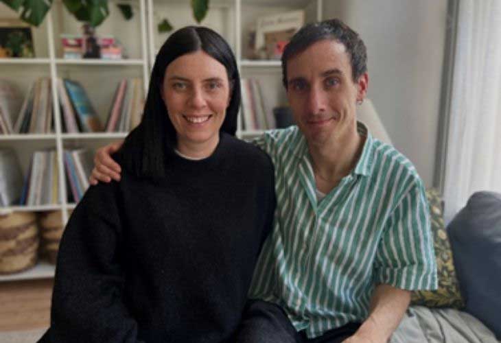 Foster carers Heather and Andrew sitting side-by-side in-front of bookcase