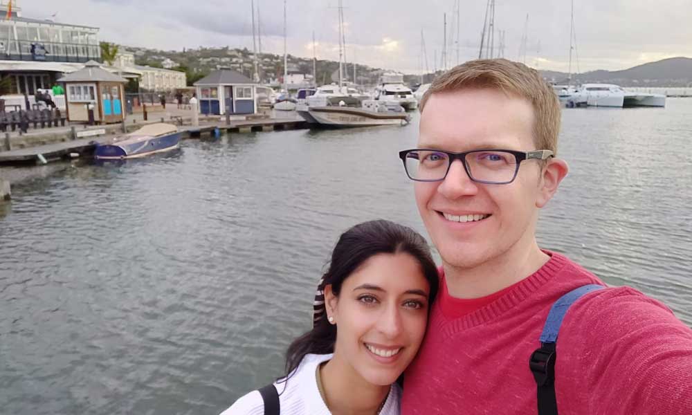 Male and female couple taking selfie at harbour