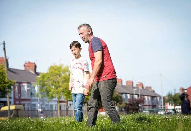 Foster carer stephen playing football with young person at park