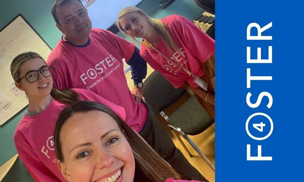 Members of the Fostering Liverpool team wearing matching foster 4 t-shirts at a pop-up event