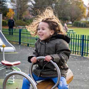 Child happy on see-saw